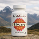  AyuMantra Bilva SPL Tablets bottle on rock with mountain lake backdrop, Aegle marmelos supplement.