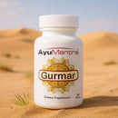  Gurmar Tablets bottle on desert sand dunes, AyuMantra dietary supplement label visible.